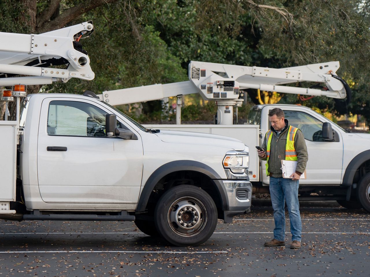 Fleet manager inspecting utility trucks