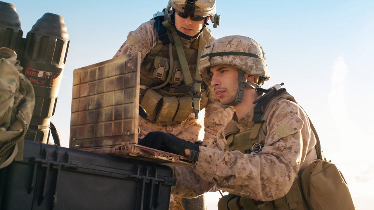 Soldiers using the laptop