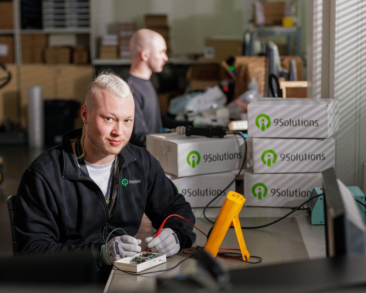 9Solutions worker assembling hardware products