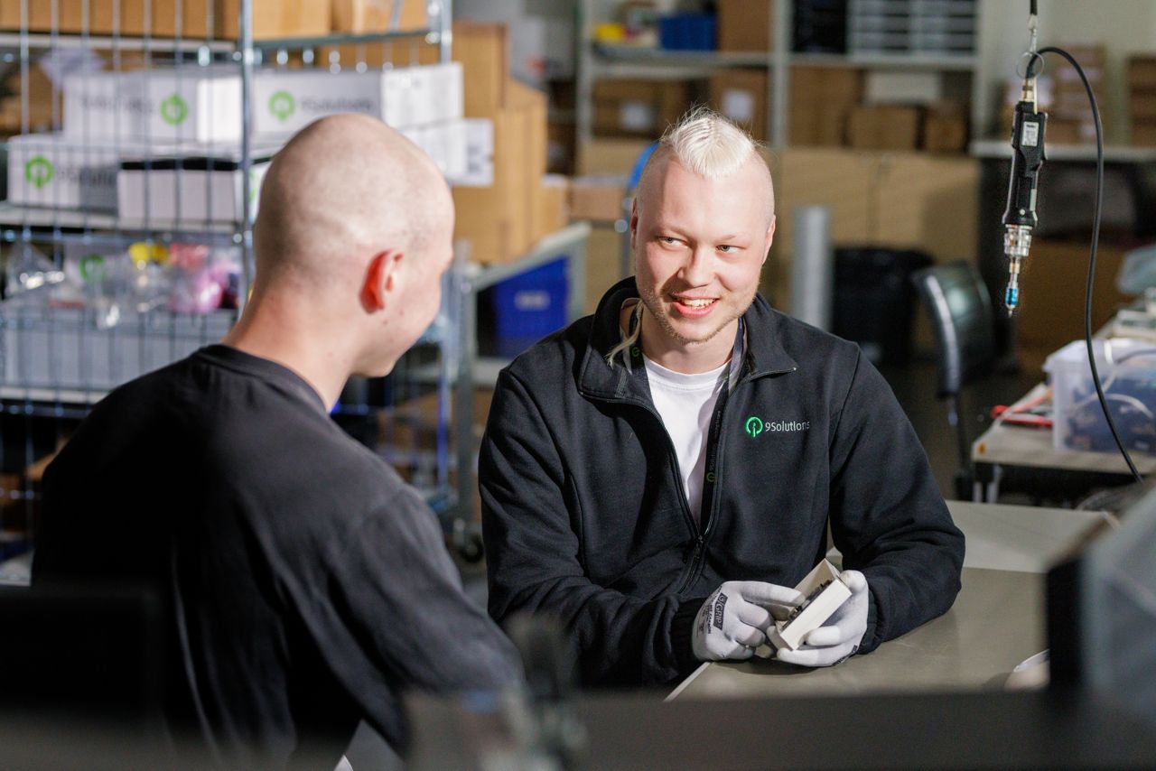 two technicians working on a product