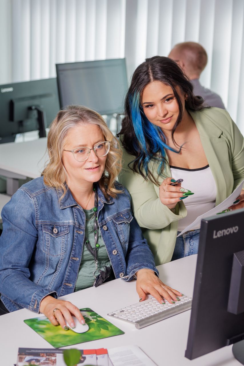 two women looking at a computer