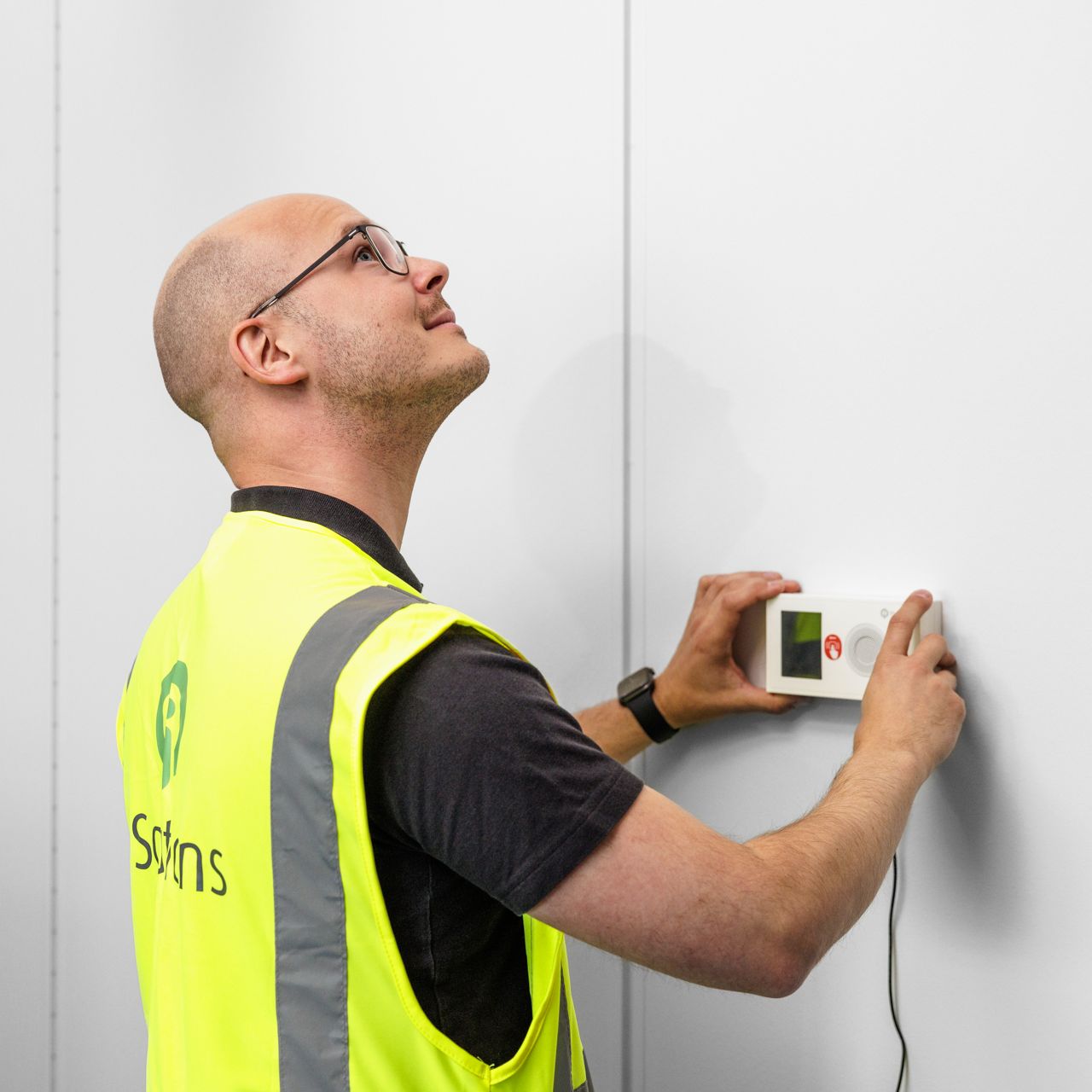 9Solutions techician installing a call phone