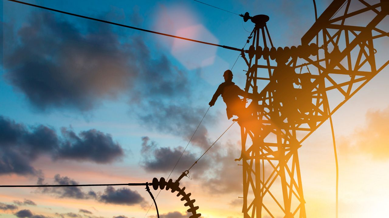 An electrician working on the power line