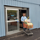 A man pushes a cart of donated school supplies through automatic doors