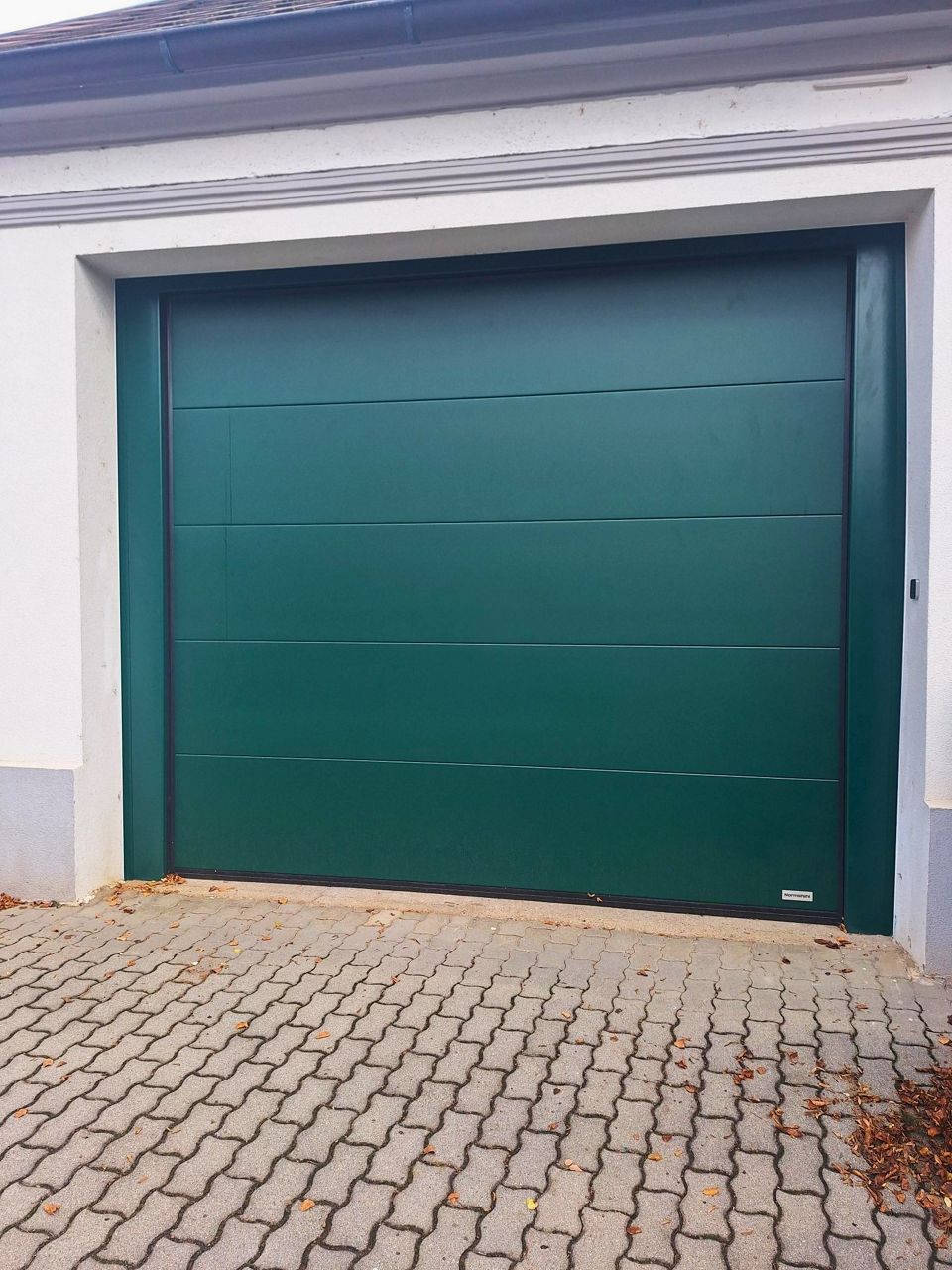 Smart sectional overhead door in the attractive color RAL6005 moss green