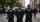 Three police officers standing on city street