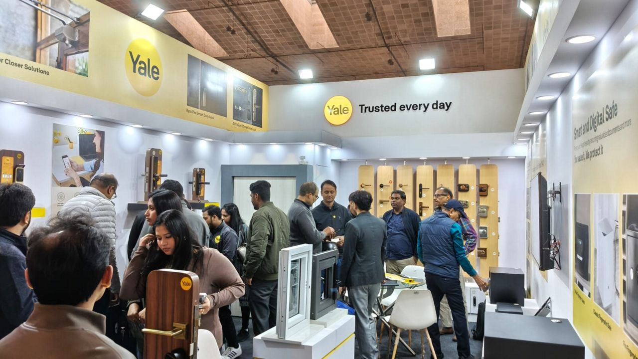 Visitors exploring Yale smart home security solutions at ABID Expo