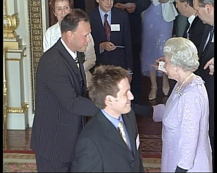Steve shaking hands with the Queen Elisabeth at Buckingham Palace