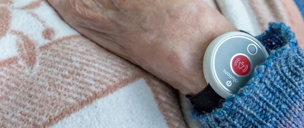 Safety button on a old woman