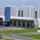 Loading docks with trailer at the DSV facilities. A big grey building with grey and yellow doors.