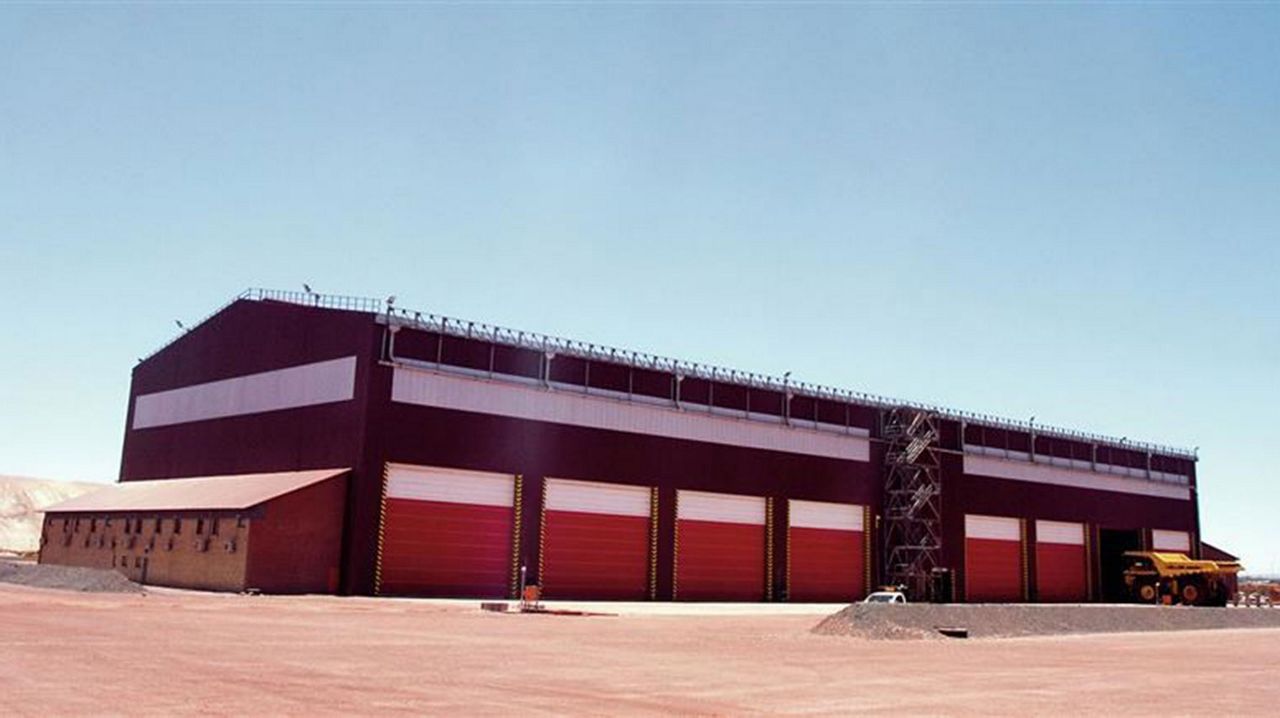 Exterior view of a Sishen mine building. A big red building with red doors.