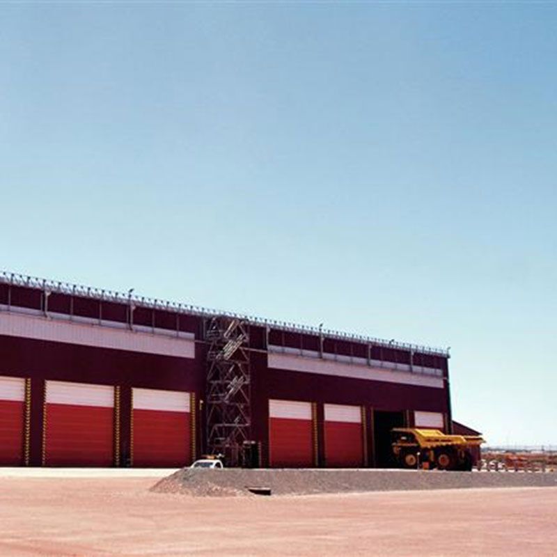Exterior view of a Sishen mine building. A big red building with red doors.