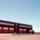 Exterior view of a Sishen mine building. A big red building with red doors.