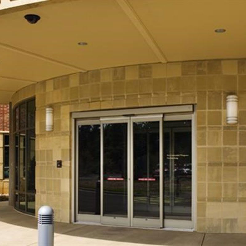 Sliding doors entrance to The Rosedale Medical Center. A yellow brick building with automatic glass sliding doors. 
