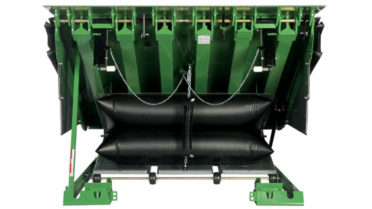 Air-powered pit-style loading dock leveler with a safety barrier lip. 