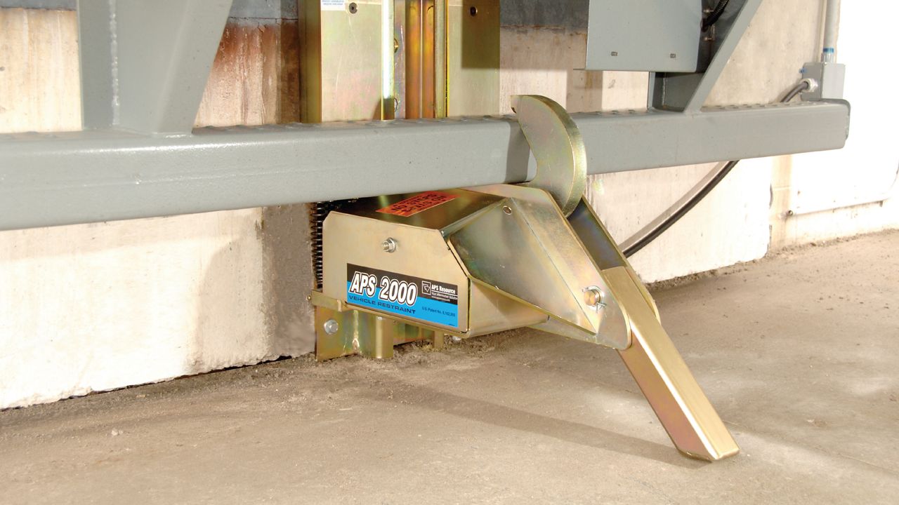  A heavy-duty industrial device featuring a versatile restraining arm and durable construction for enhanced vehicle security.