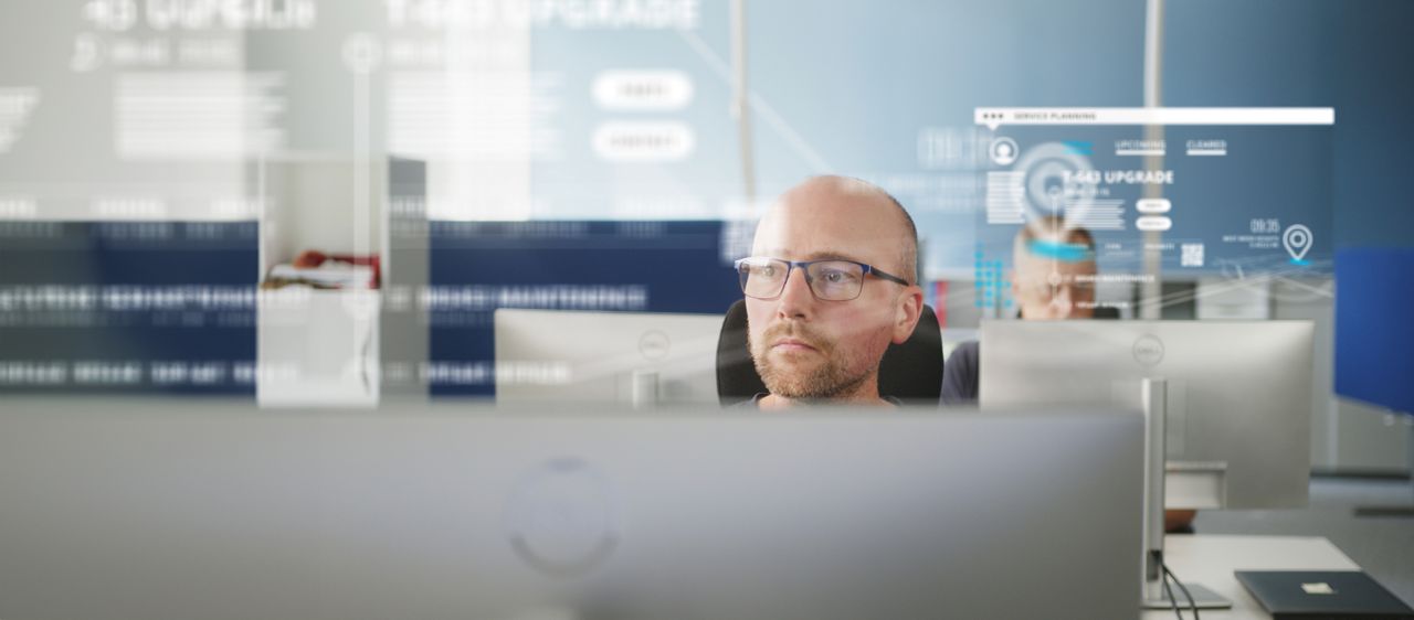 man at computer looking at door data
