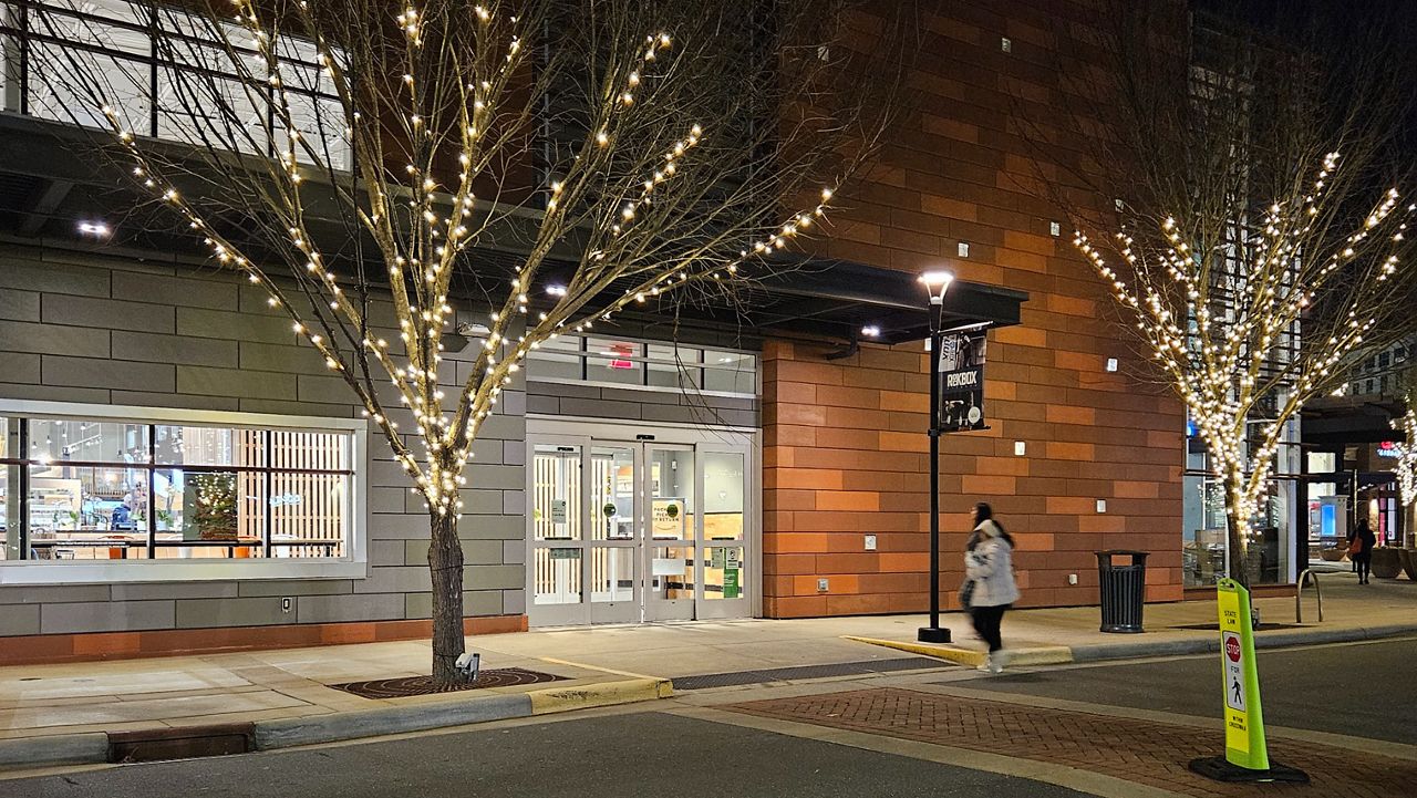 ASSA ABLOY automatic sliding door at the entrance of a mixed-use building.