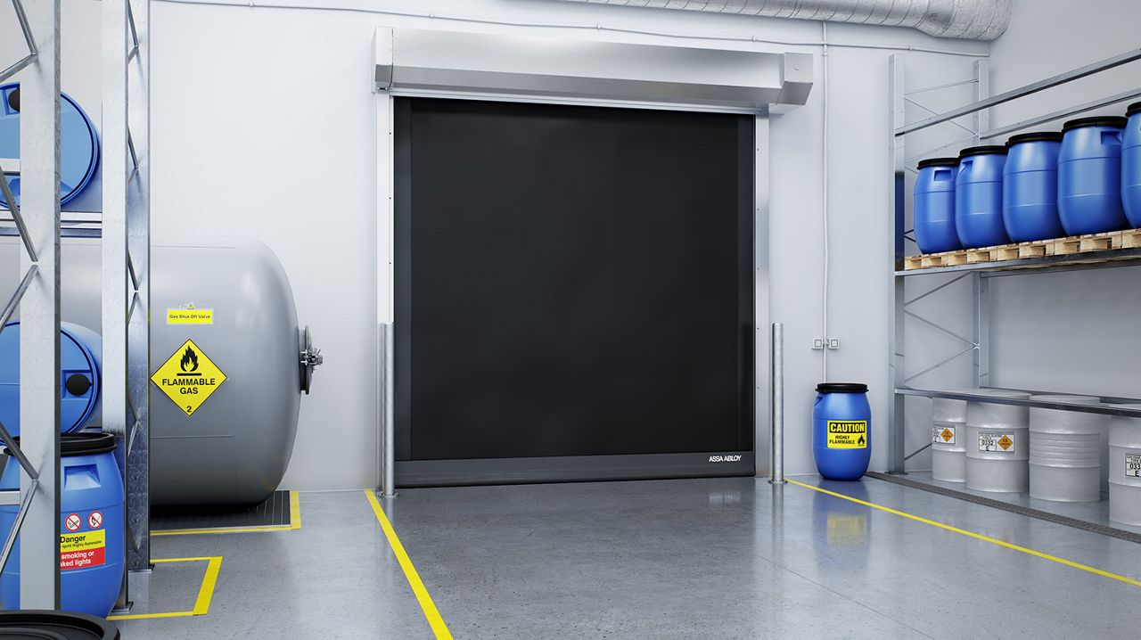 A black high speed door in a warehouse environment.