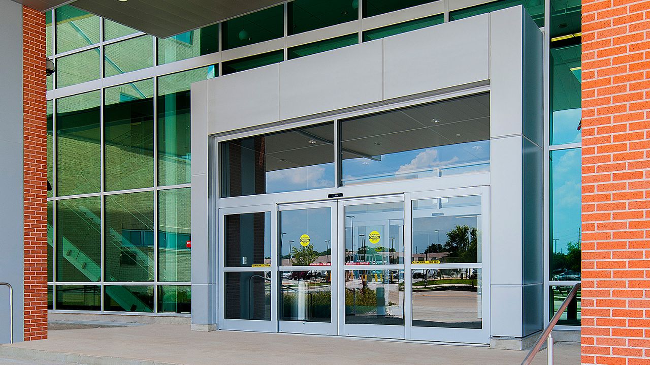 Outside view of a building with the ASSA ABLOY SL500 overhead concealed automatic sliding door.