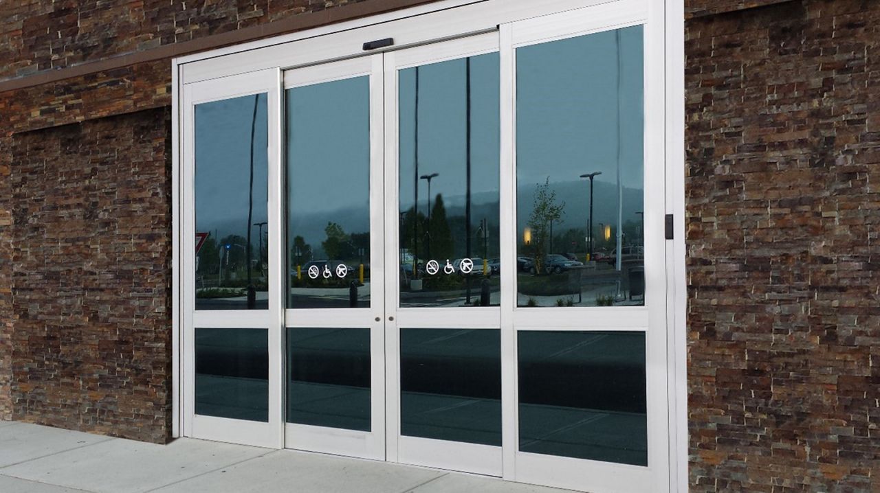 Frontview of a brown brick building with the hurricane-resistant door ASSA ABLOY SL500 Resilience R128.