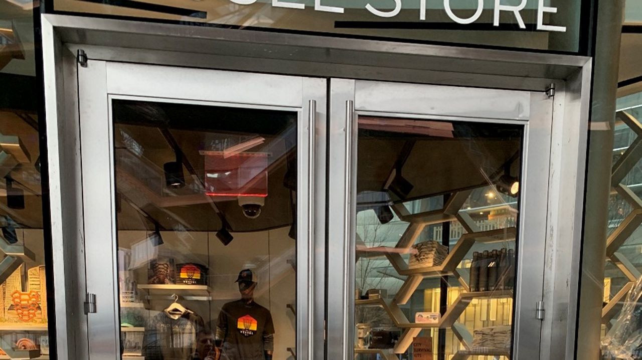 Outside view of a fashion store with ASSA ABLOY SW200i-IG In Ground Swing Door System.