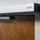 Close-up of the ASSA ABLOY SW60 Swing Door Operator on a brown wooden door.