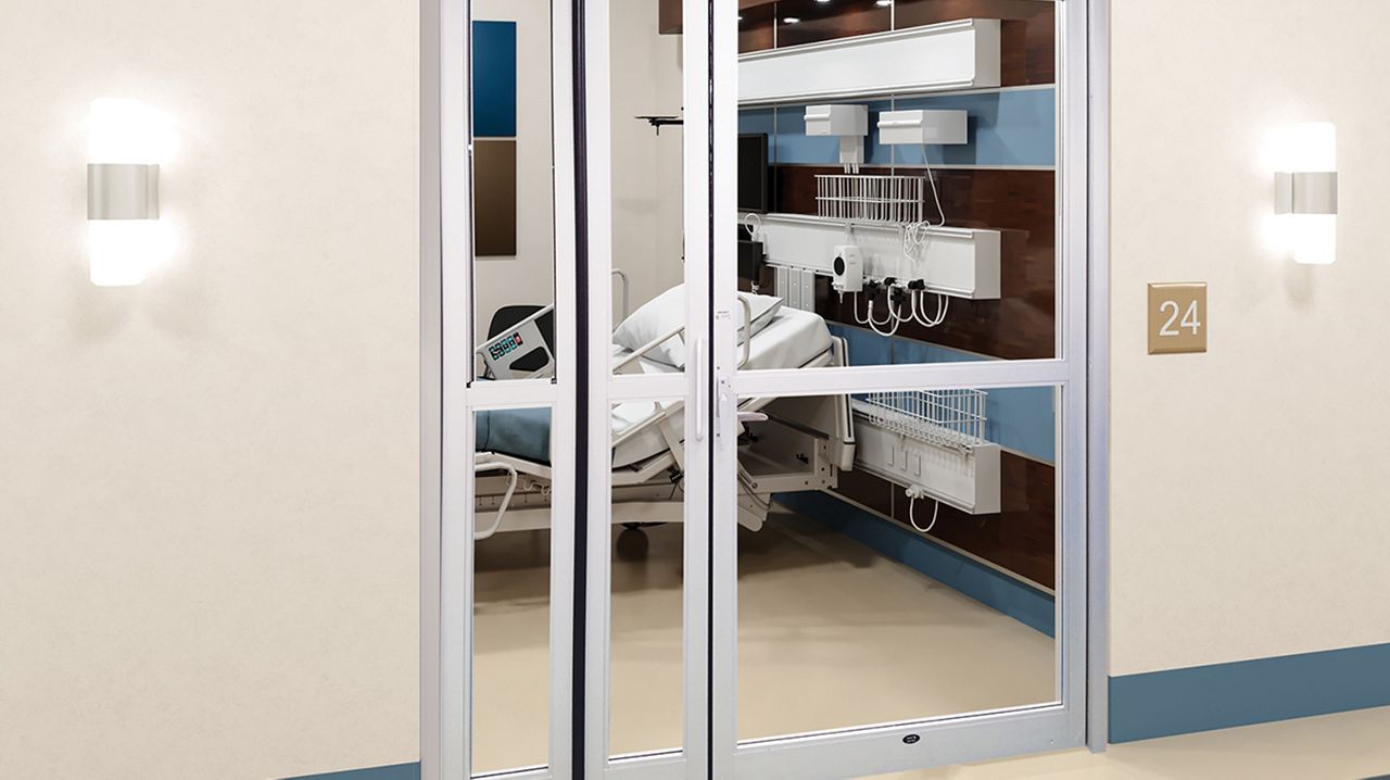 The ASSA ABLOY VersaMax 2.0 Fold ICU door in a hospital hallway.