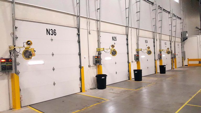 A line of loading dock doors inside of a warhouse