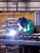 Welder welding a panel