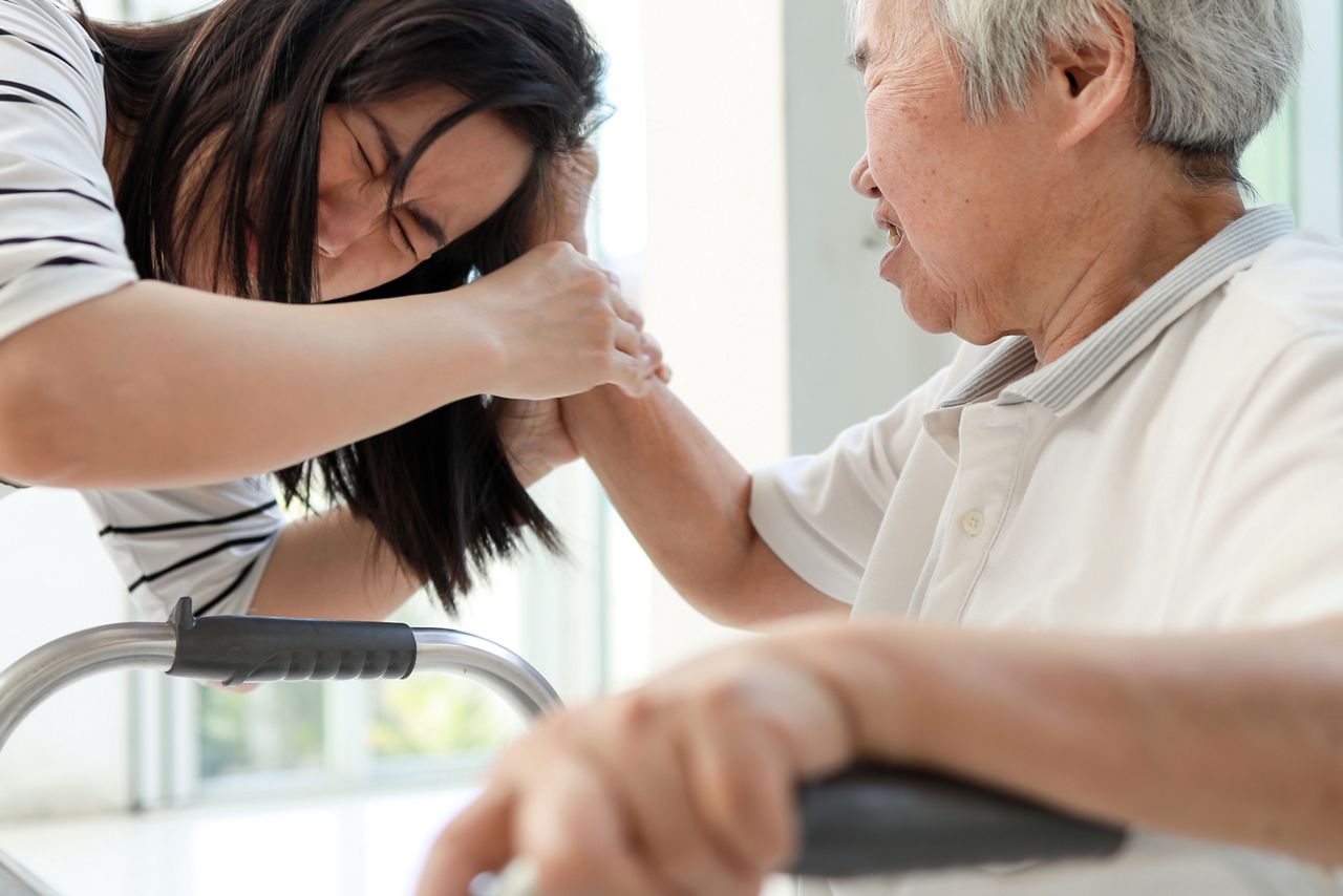 senior woman grabbing anothers hair