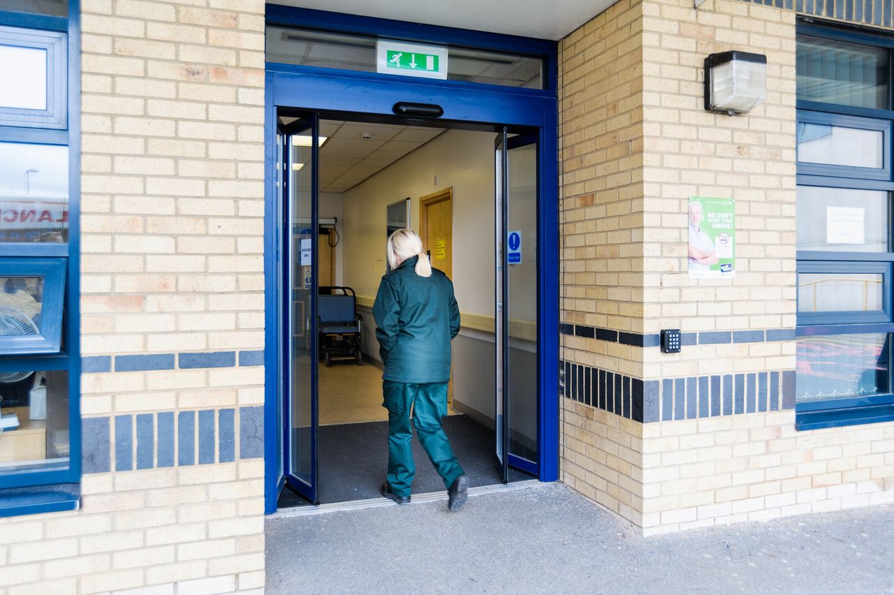 Image: /content/dam/record/com/uk/en/content-fragments/images/folding-doors/Ambulance Staff walking through FTA 20 Folding Door at Blackburn Hospital.jpg