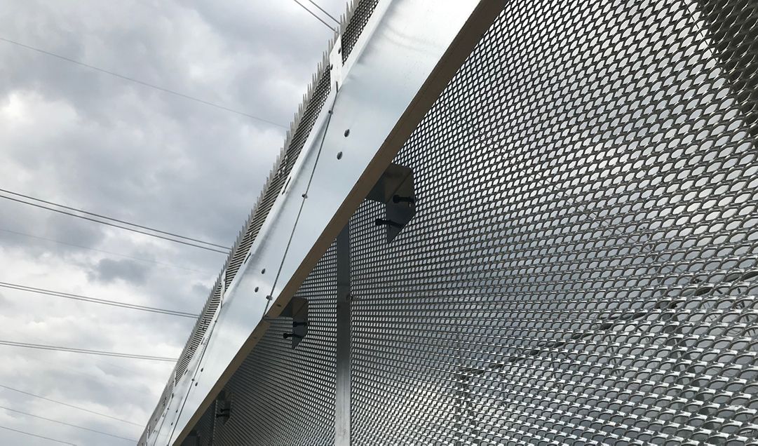 Close up view of animal mitigation shield mounted to galvanized Matrix Alpha. The view is from the ground looking up.