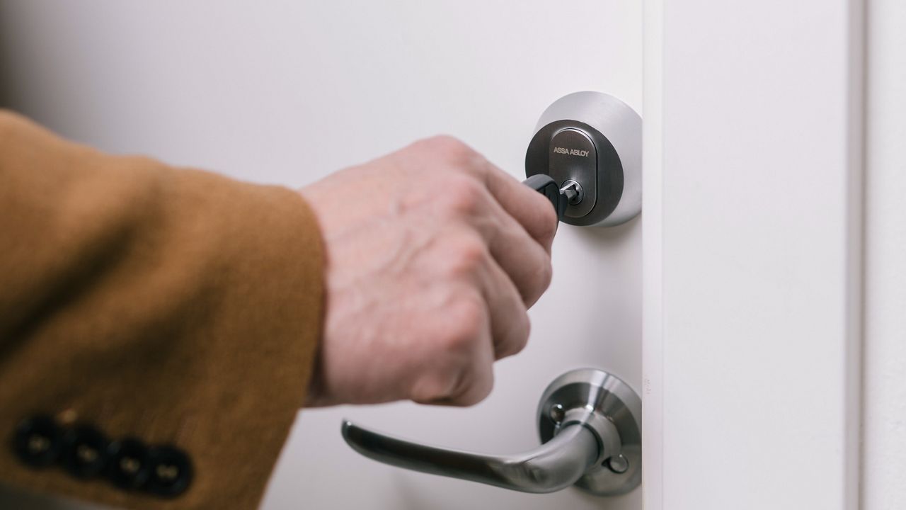 PULSE key in lock cylinder on white door.