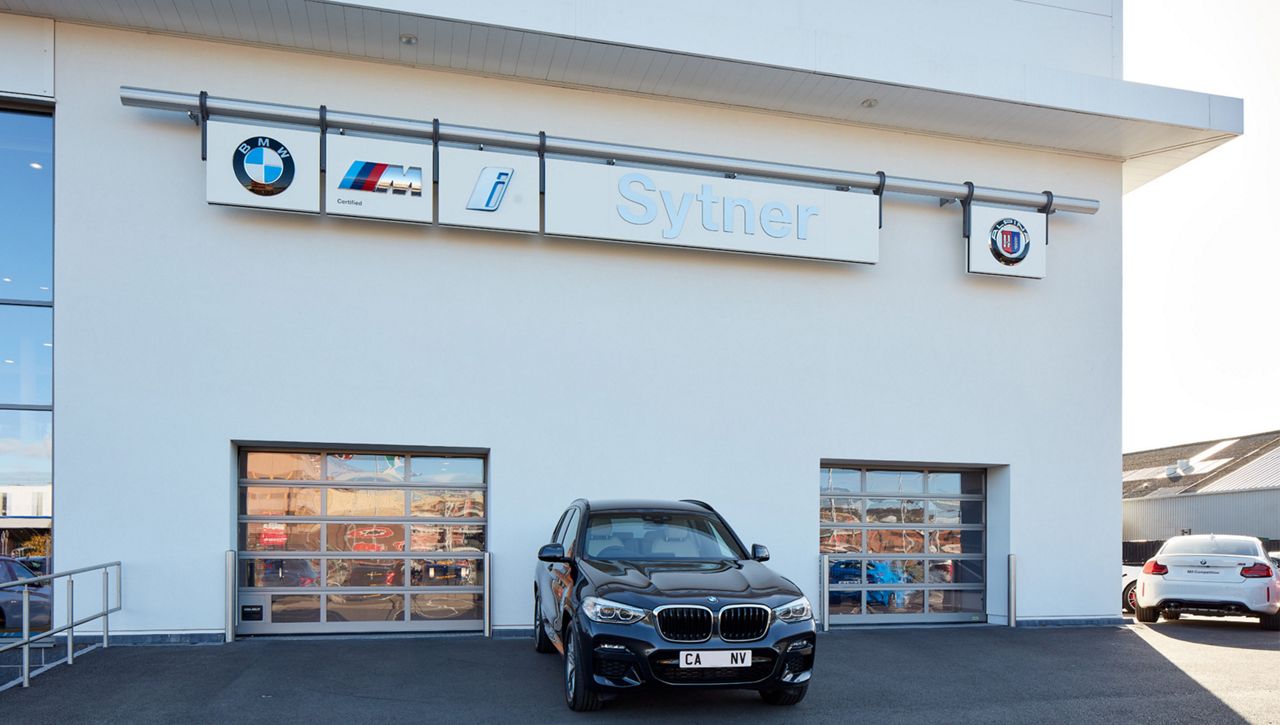 Two Crawford OH1042F sectional doors installed in the handover bays at a BMW car dealership