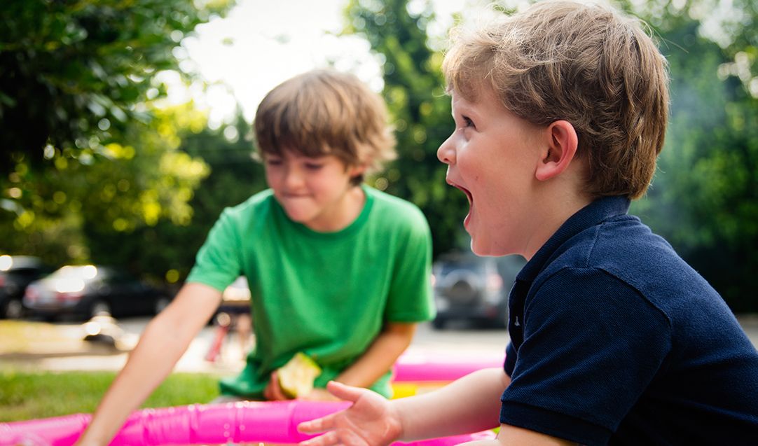 Two young boys playing outside.