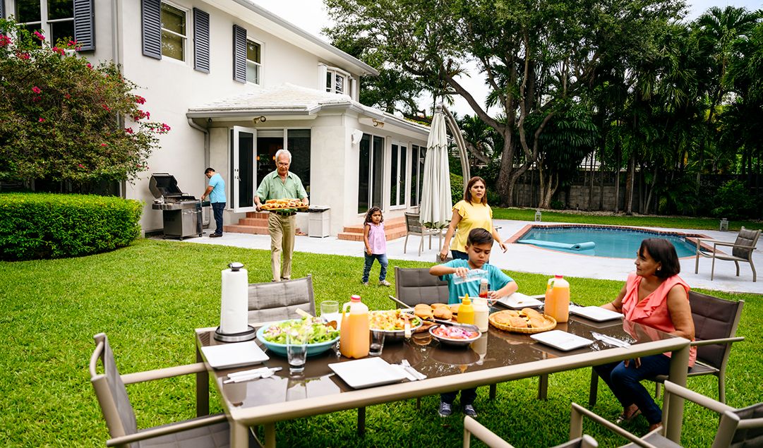 A family having a BBQ in their backyard.