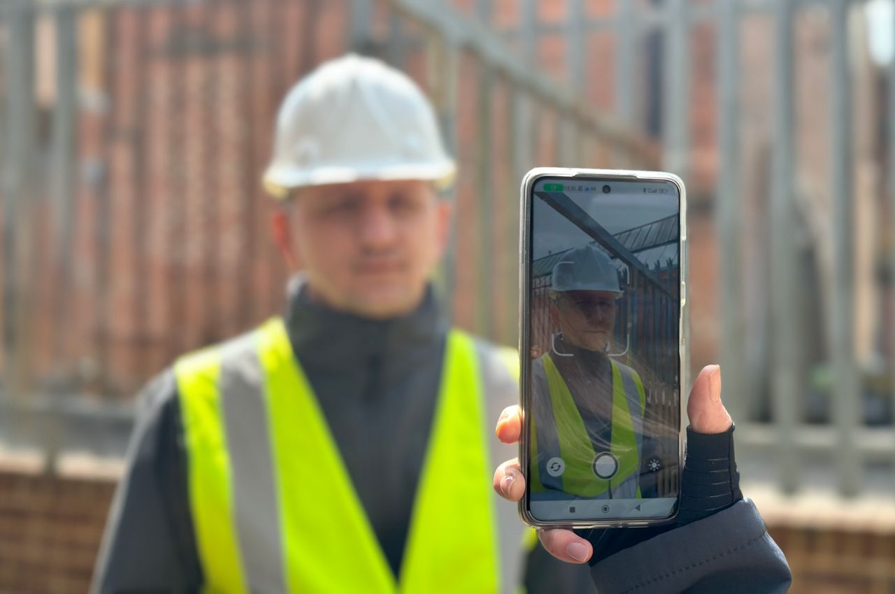 A mobile phone scanning the face of a person with the Biosite Mobile facial recognition