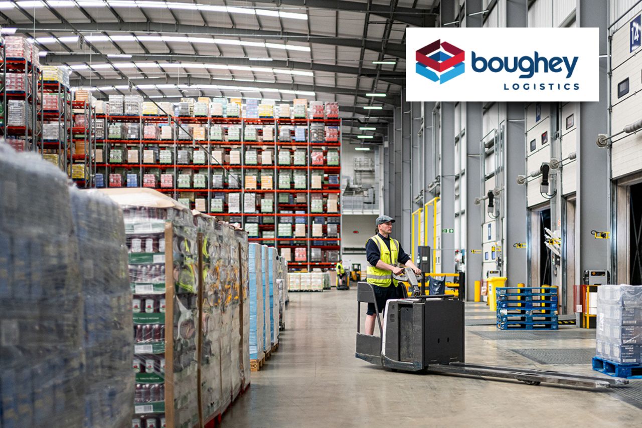 Logistics warehouse loading operations with worker transporting pallets