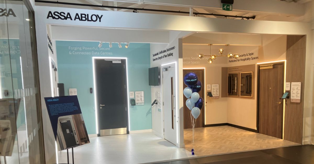 ASSA ABLOY's exhibition space at the building centre London, middle split showroom with healthcare blue section on left and brown hospitality section on the right