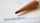 A zoomed in image of a pencil on a piece of paper with the written word "sustainability"