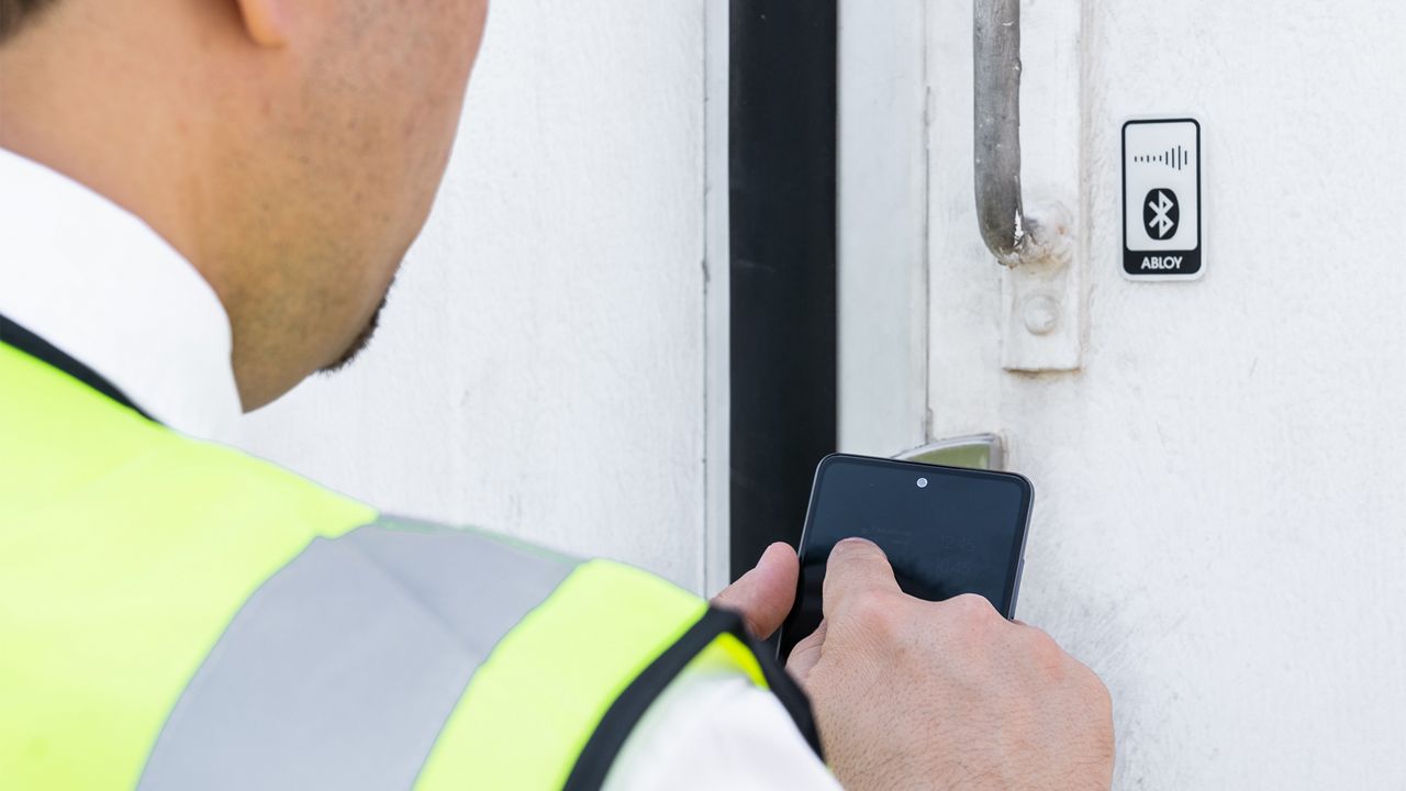 Man opening a door with their smartphone