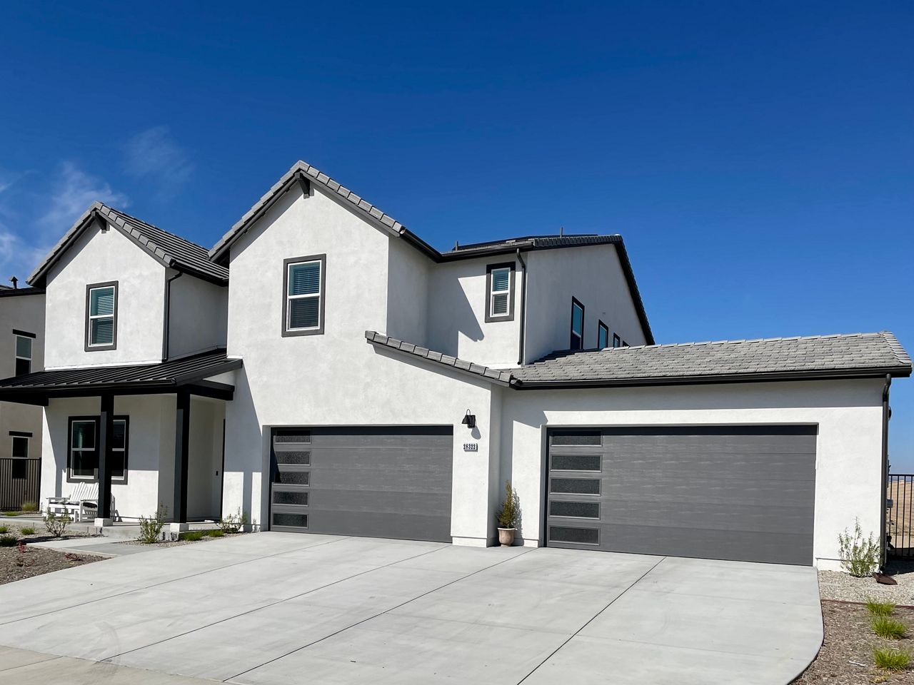 Amarr gray garage door on a white stucco home