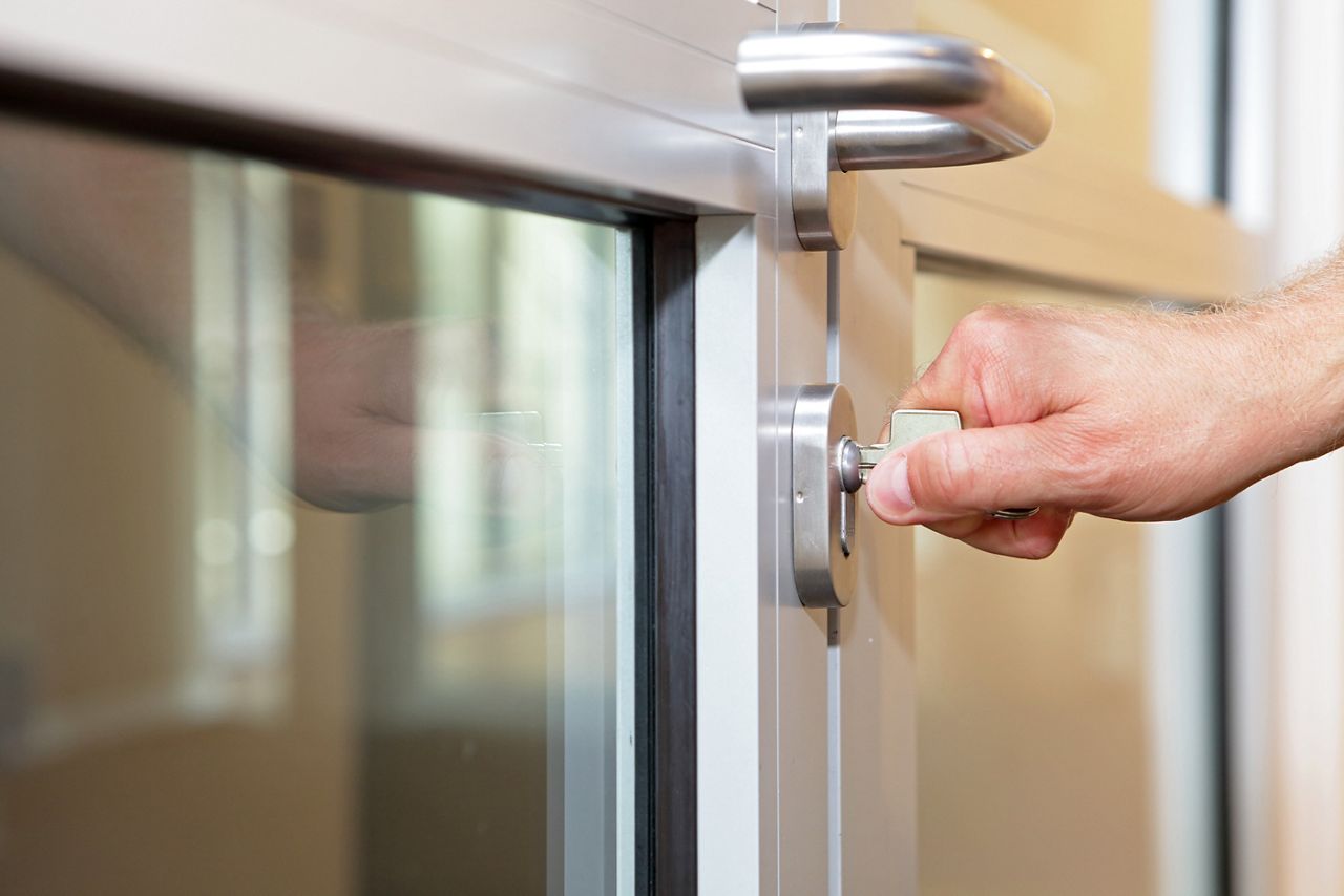Man opening commercial door with key