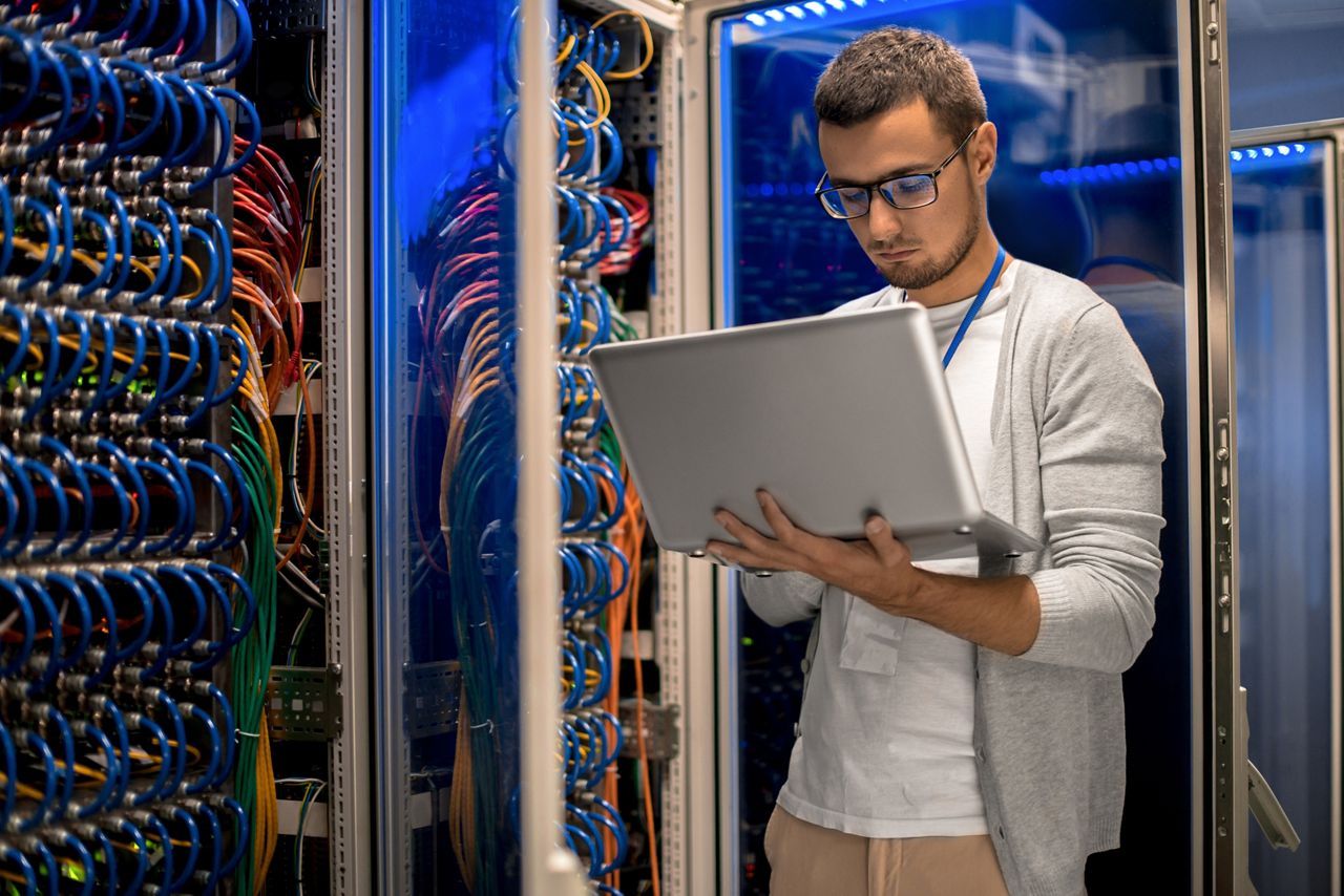 Data center technician working on laptop