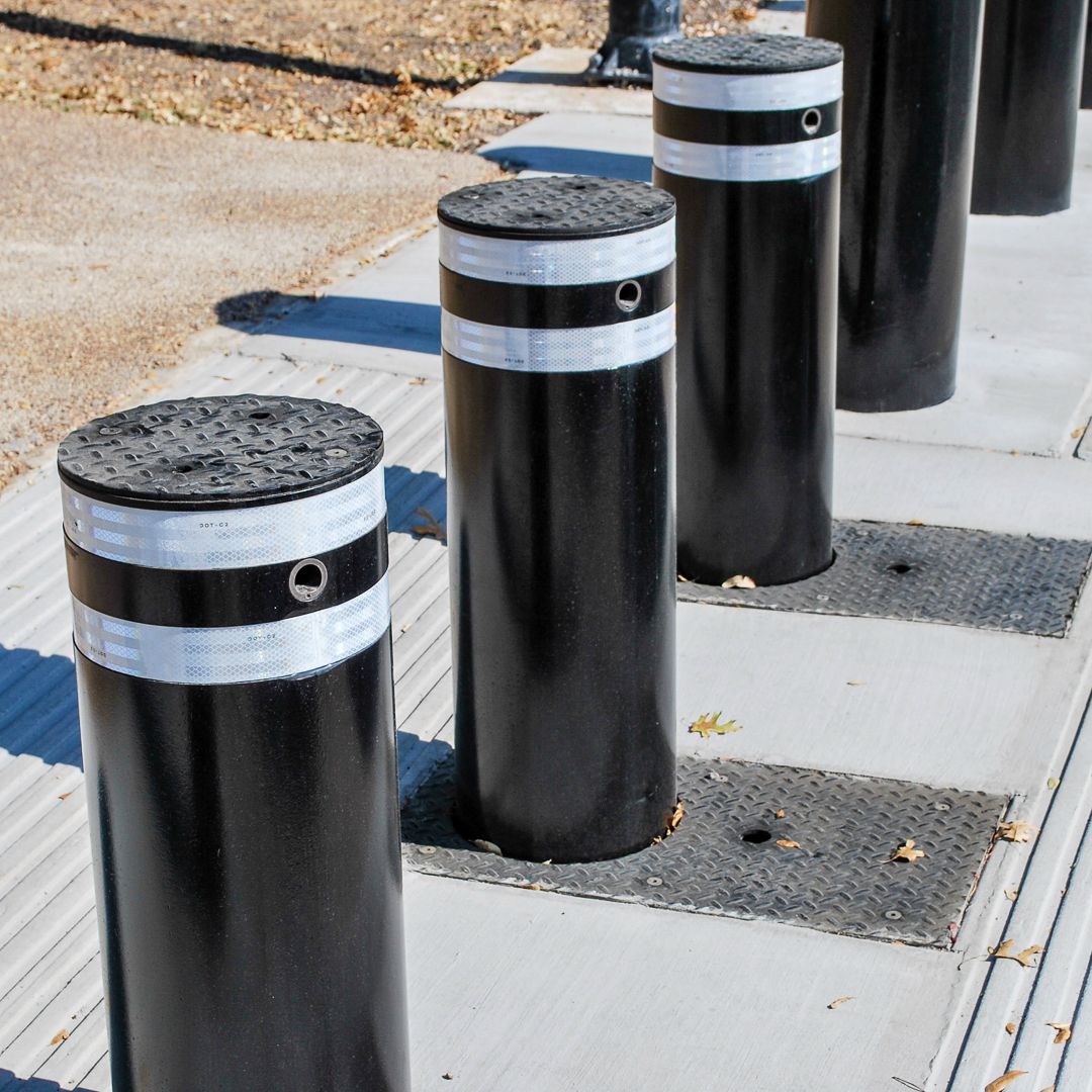 Defender automatic bollards black with white stripes