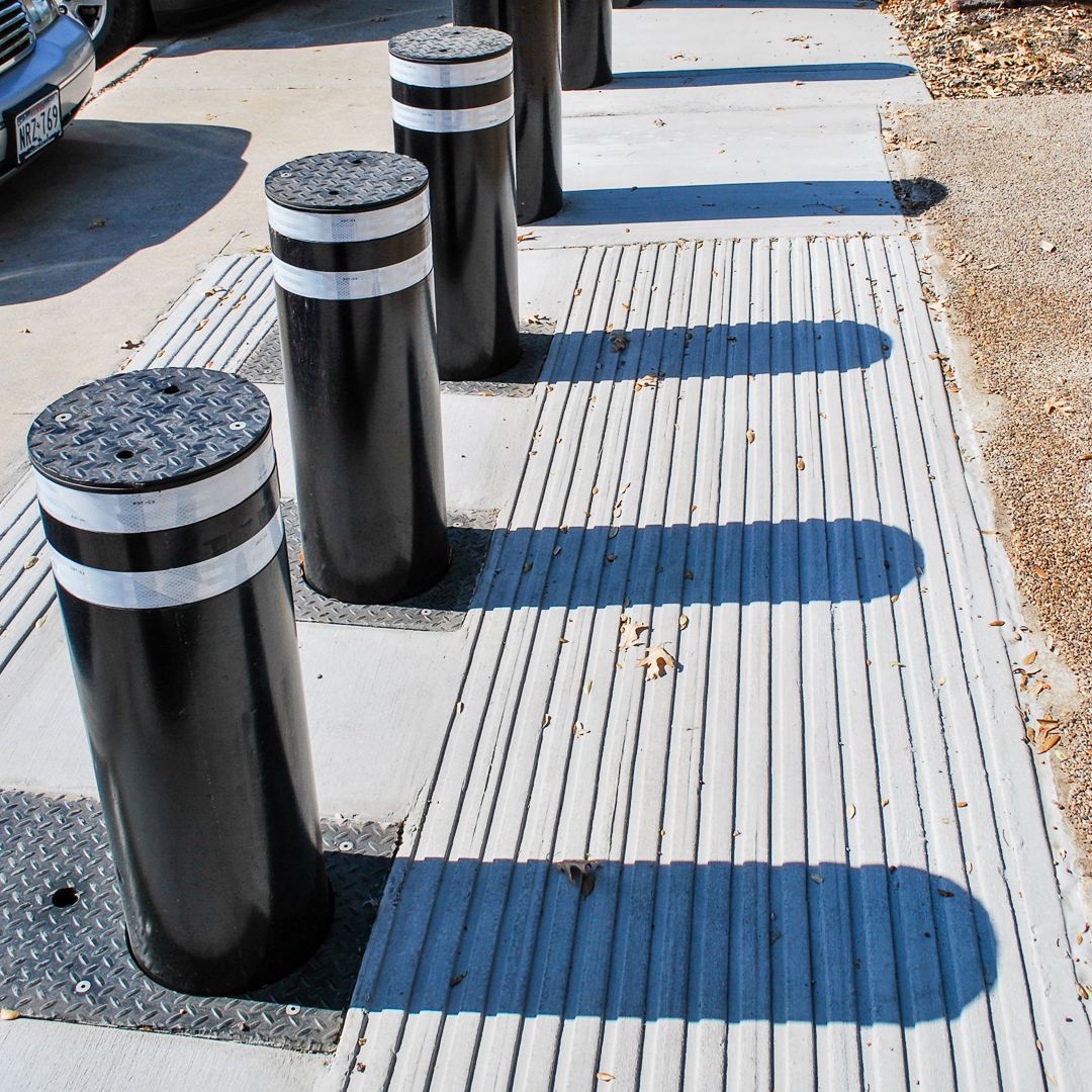 Defender automatic bollards black with white stripes