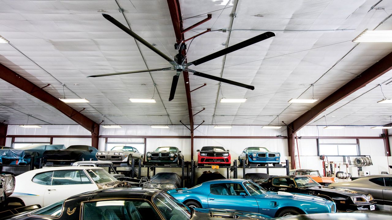 Image: A Direct Drive Fan hanging in a commercial garage.