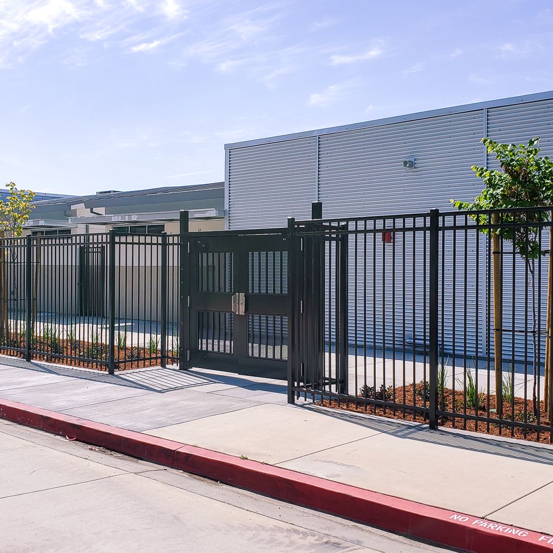 Exodus double swing gate with pickets and infill.