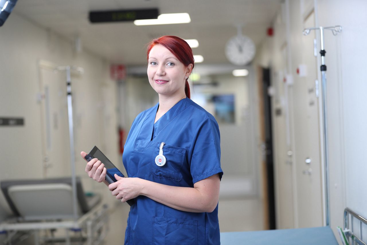 nurse holding a tablet and smiling